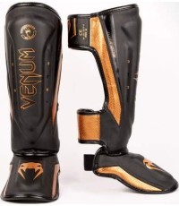 Venum Elite Evo blauzdų apsaugos, juoda/bronzinė